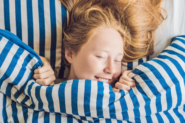 Premium Photo | Young beautiful woman woke up in bed close-up.