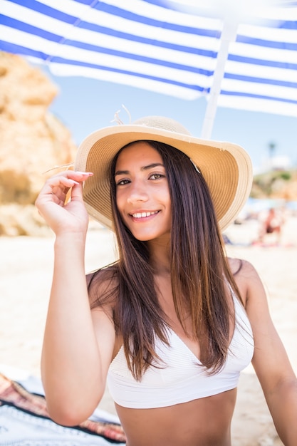 https://image.freepik.com/free-photo/young-beauty-latin-woman-bikini-straw-hat-sitting-sun-umbrella-beach-near-sea-coast_231208-5331.jpg