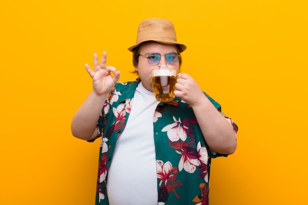 Premium Photo | Young big size man with a pint of beer against flat wall