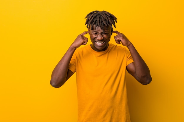 Premium Photo | Young black man wearing rastas over yellow covering ...