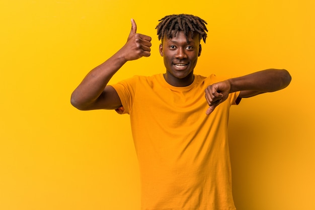 Premium Photo | Young black man wearing rastas over yellow showing ...