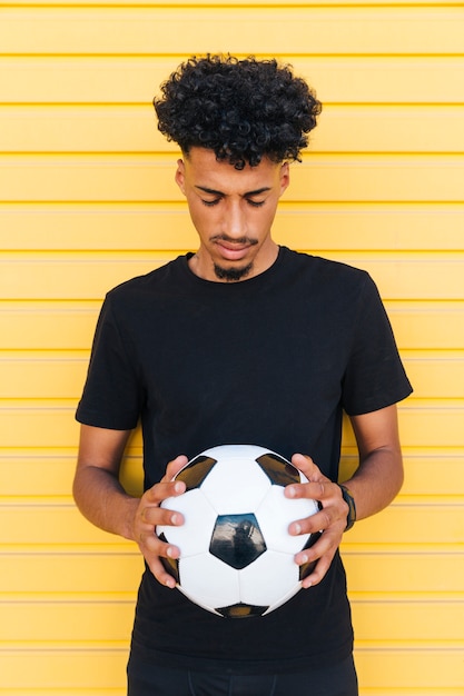 Il Giovane Uomo Di Colore Con Il Pallone Da Calcio Ha Chiuso Gli Occhi Foto Gratis