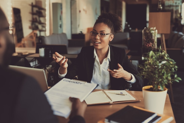 Young black woman interviewing man in the office Premium Photo