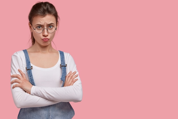 Free Photo | Young brunette woman in denim overalls