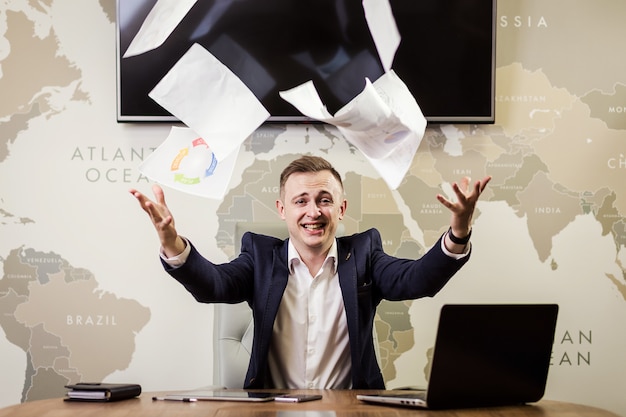 Young businessman throwing some paper sheets in the air,business, people, stress, emotions and fail concept - angry businessman throwing papers in office Premium Photo
