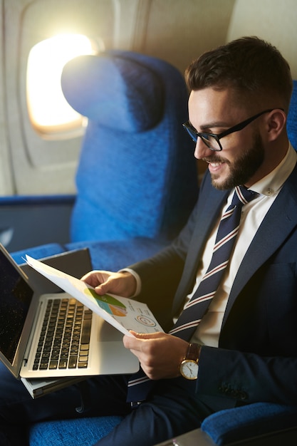 Premium Photo | Young businessman working in plane