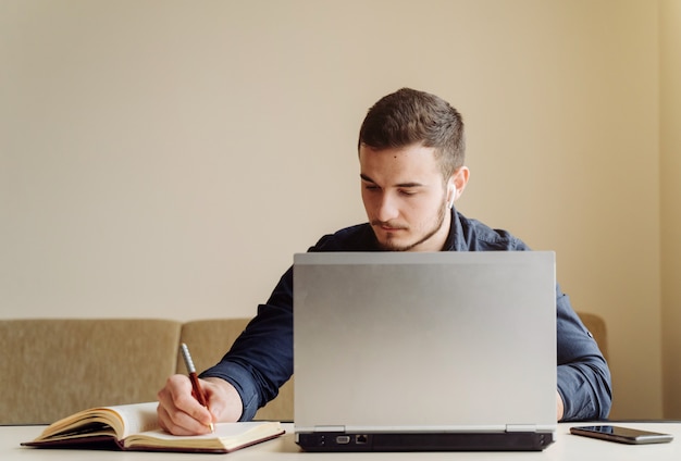 Young businessman working with computer remotely Free Photo