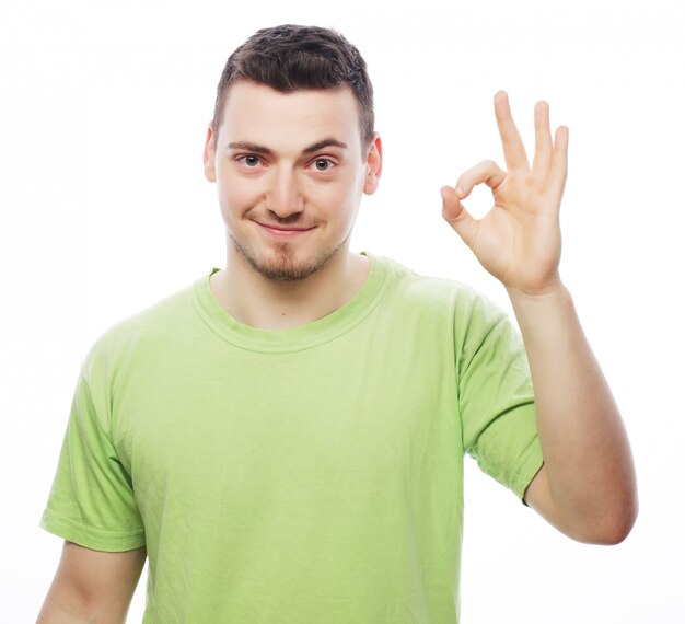 Premium Photo | Young casual man showing the victory gesture