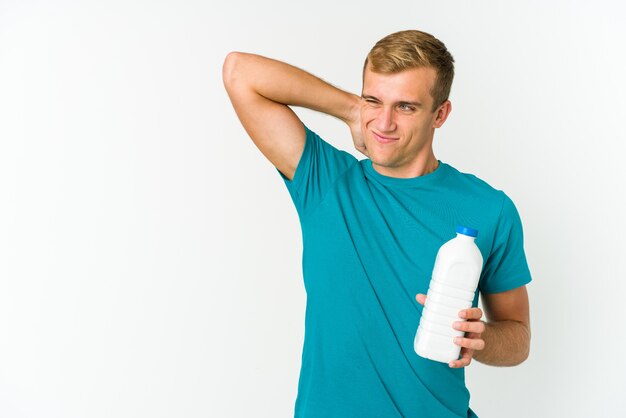 Premium Photo | Young caucasian man drinking milk isolated on white ...