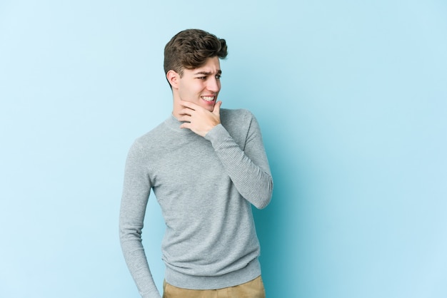 Premium Photo | Young caucasian man touching back of head, thinking and ...