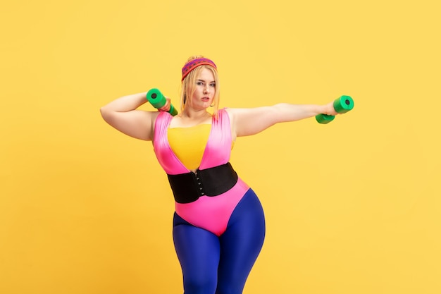 Fremsyn Crack pot ekko Free Photo | Young caucasian plus size female model's training on yellow  wall. copyspace. concept of sport, healthy lifestyle, body positive, fashion,  style. stylish woman practicing with green weights.