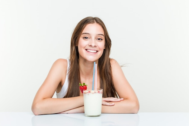 Premium Photo | Young caucasian woman drinking a smoothie