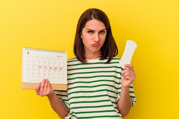 Premium Photo | Young caucasian woman holding calendar and compress ...