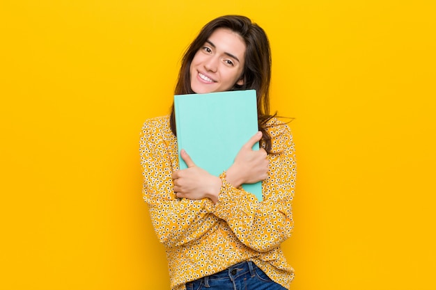 Premium Photo | Young caucasian woman holding some notebooks