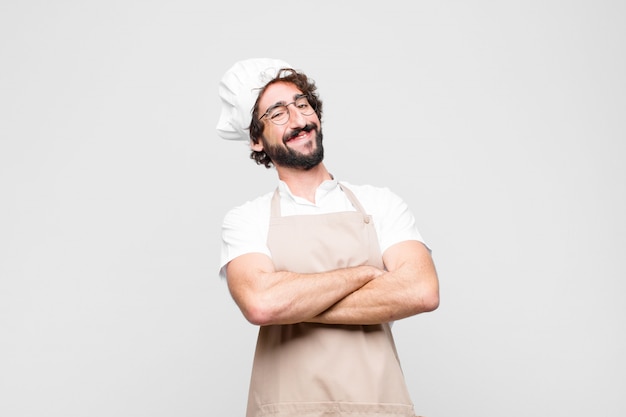 Premium Photo | Young chef laughing happily with arms crossed