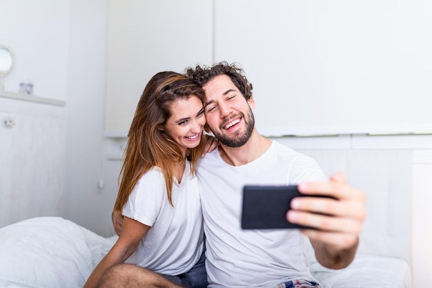 Premium Photo Young Couple In Bed Taking Selfie On Mobile Phone 