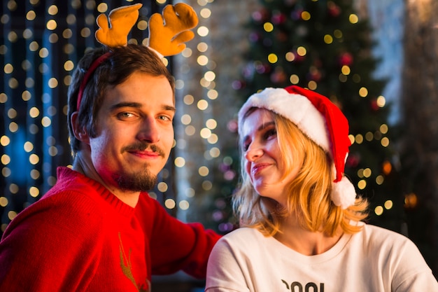 Free Photo | Young couple in front of christmas tree