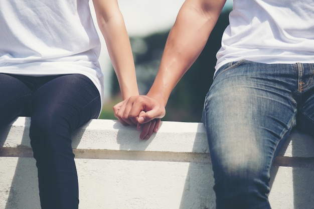 Young couple holding hands walking away together Photo | Free Download