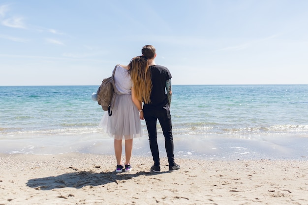 Free Photo | Young couple is standing near sea