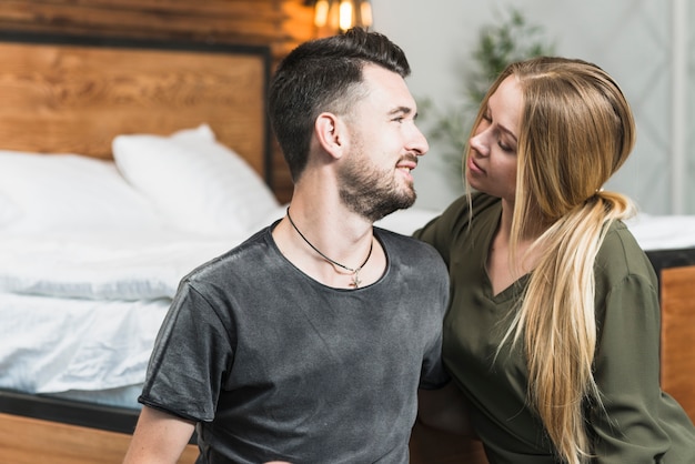 Free Photo | Young couple sitting in bedroom looking at each other