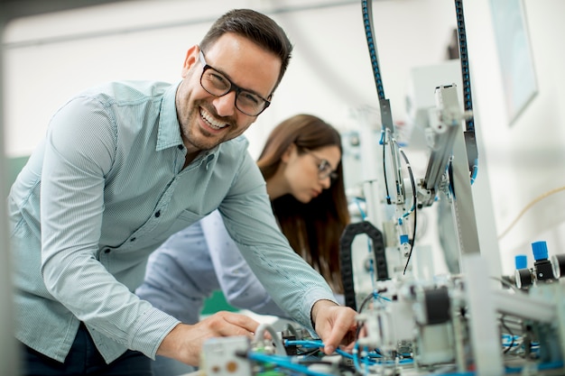 Premium Photo | Young couple of students at robotics lab