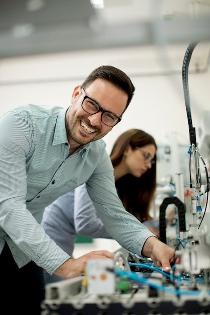 Premium Photo | Young couple of students at robotics lab