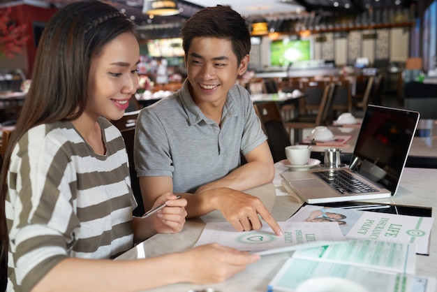 Young couple studying details of life insurance policy ...