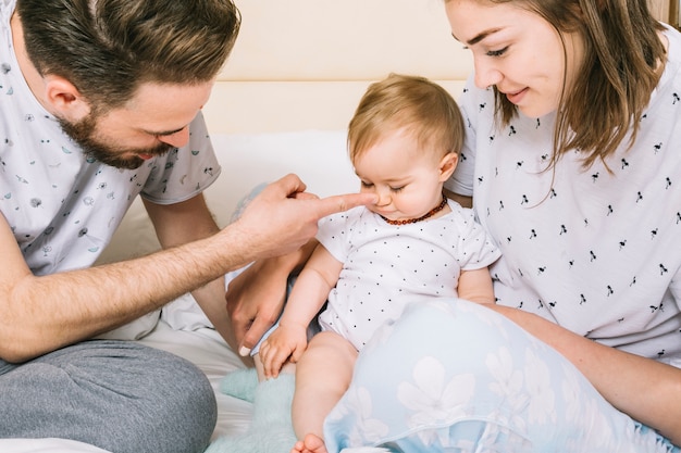 Free Photo Young Couple With Baby In The Morning