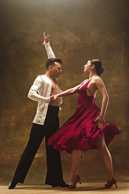 Premium Photo The Young Dance Ballroom Couple In Gold Dress Dancing