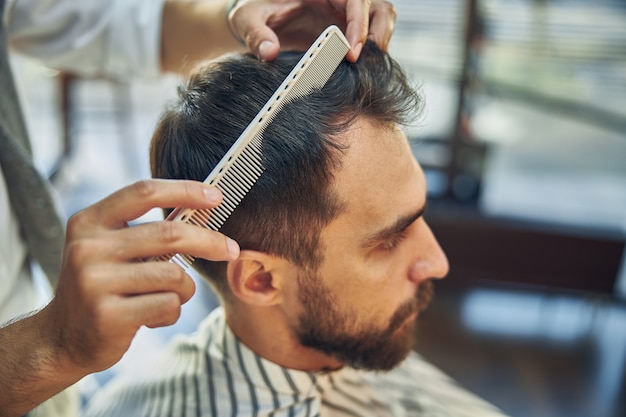 Premium Photo Young Dark Haired Male Barbershop Client Looking At