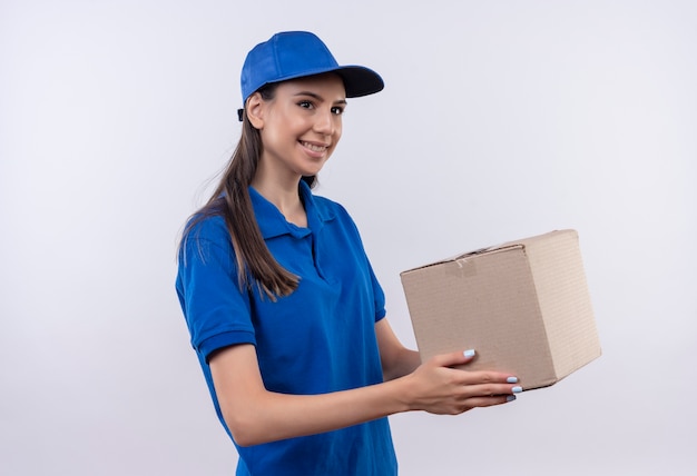 Free Photo Young Delivery Girl In Blue Uniform And Cap Holding Box Package Smiling Confident 2405