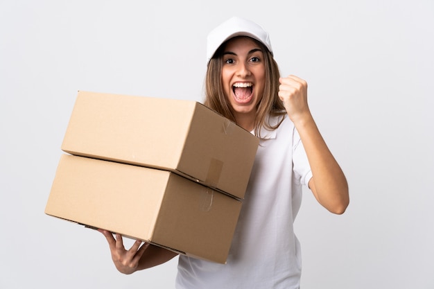 Young delivery woman over white wall celebrating a victory in winner  position | Premium Photo