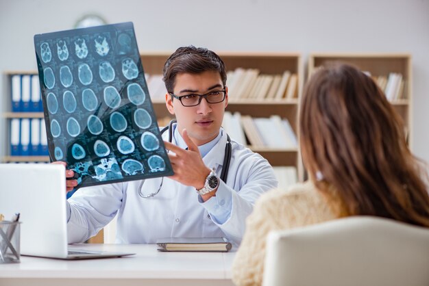 Premium Photo | Young doctor looking at computer tomography x-ray image