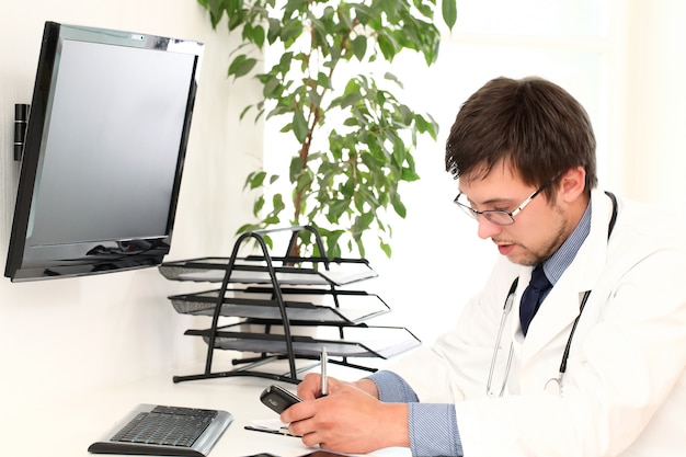 Free Photo | Young doctor working in his office