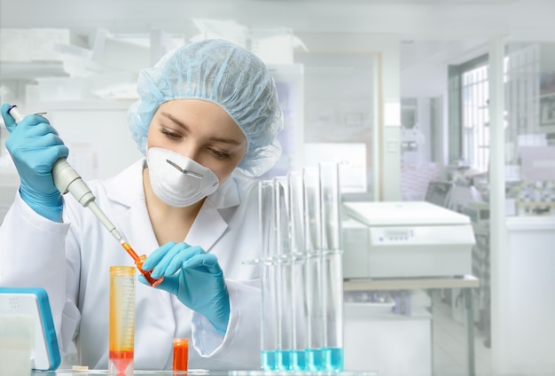 Young energetic female tech or scientist works in laboratory Premium Photo