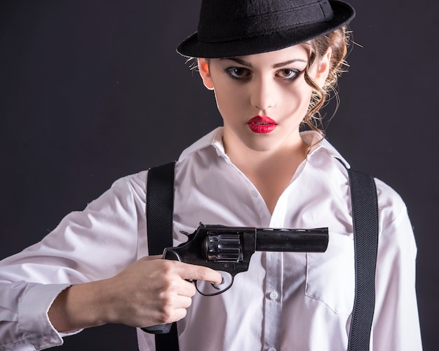 プレミアム写真 銃を保持している若い女性ギャング