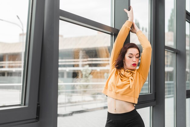 Young Female Hip Hop Dancer Posing In From Of Window Free Photo