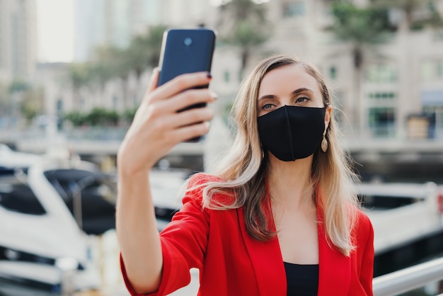 Premium Photo | Young female model in red jacket wearing reusable face ...