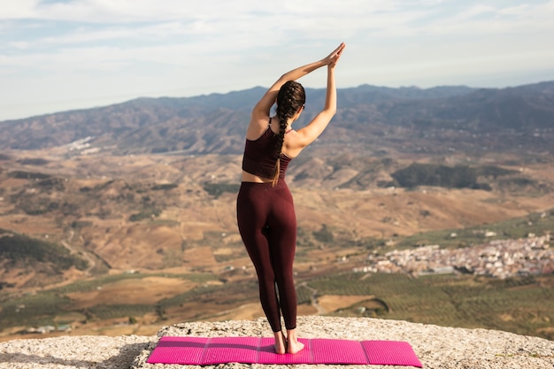 Young female on mountain practicing yoga Free Photo