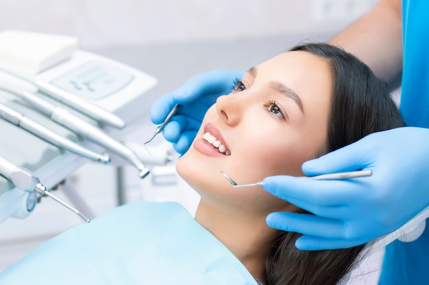 Premium Photo Young Female Patient With Pretty Smile Examining Dental Inspection At Dentist Clinic