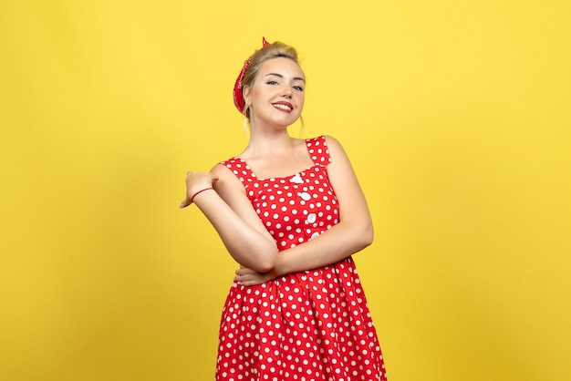 Free Photo Young Female In Red Polka Dot Dress Smiling On Yellow 9873