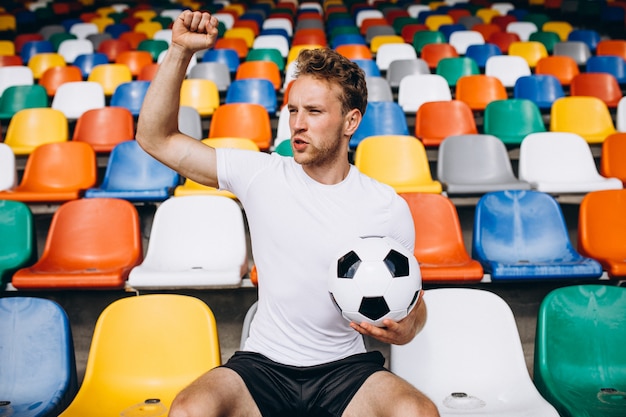 Young football player at tribunes watching the game Free Photo