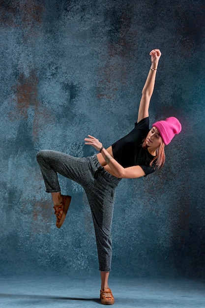 Free Photo | Young girl break dancing on wall background.