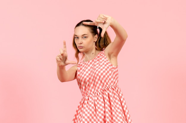 Free Photo Young Girl In Cute Pink Dress Smiling And Taking Picture With Her Hands On Pink