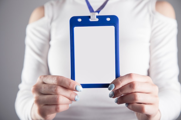 Premium Photo | Young girl holds an id card on a gray scene