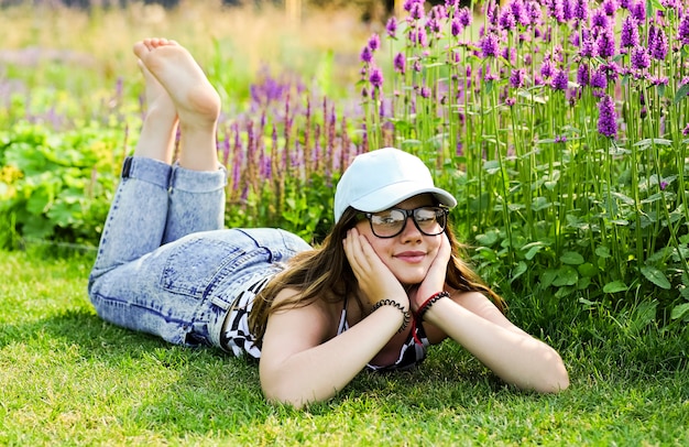 Premium Photo Young Girl Is Lying With Bare Feet On The Green Grass