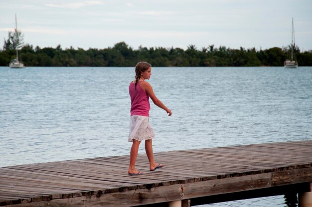 Premium Photo | Young girl on a pier at placencia in belize