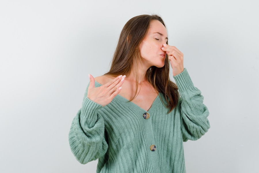 Free Photo | Young girl pinching nose due to bad smell in knitwear and ...