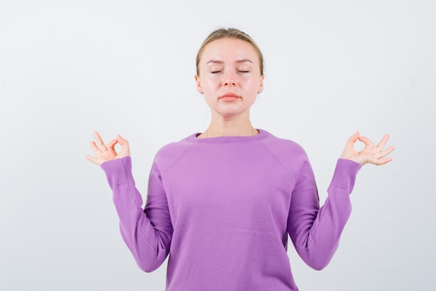 Free Photo | Young girl showing an ok hand gesture on white background