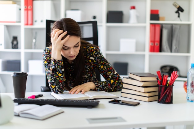 Premium Photo | A young girl sitting in the office at the computer desk ...